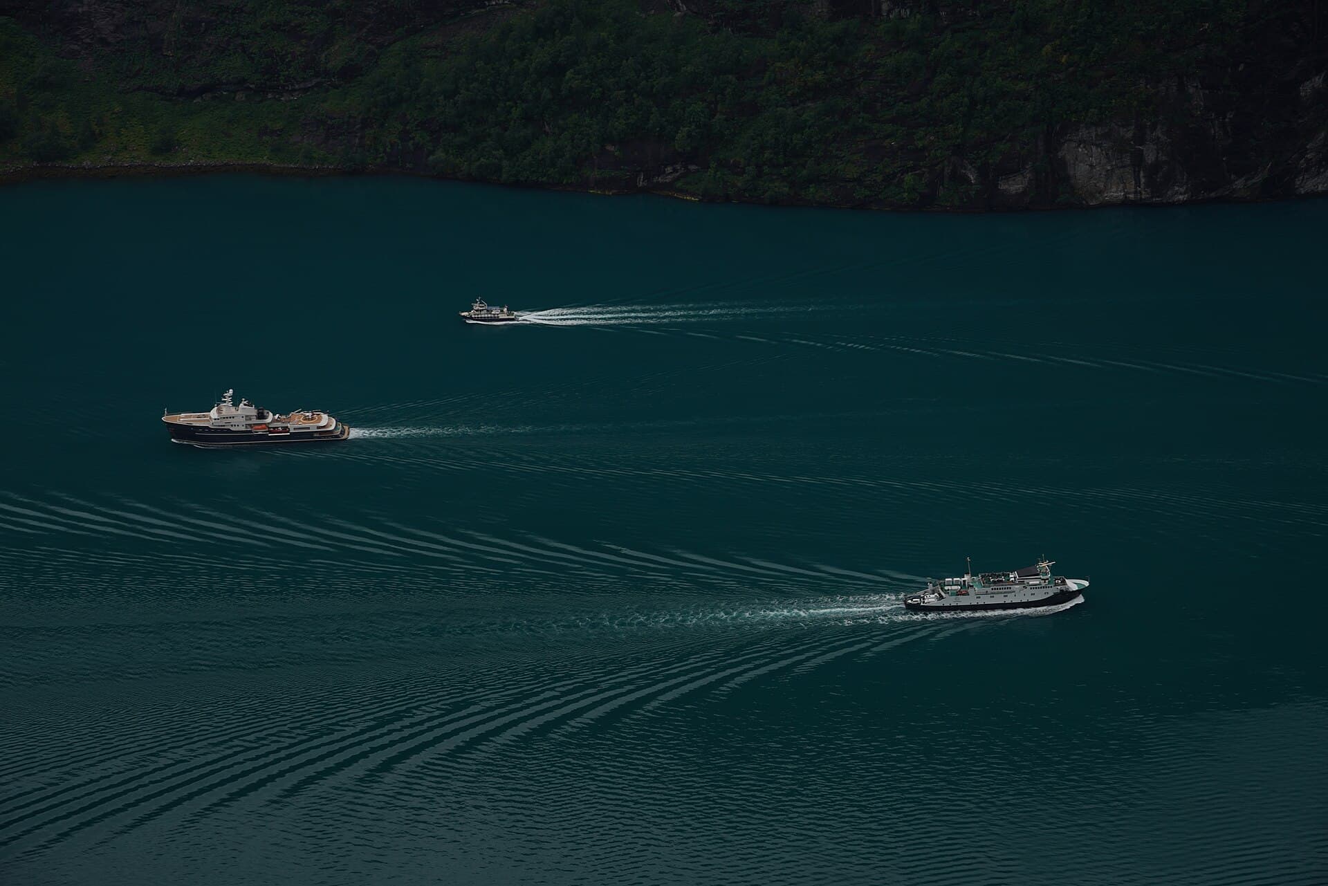 A deep green fjord between mountain walls at Geiranger, Norway.