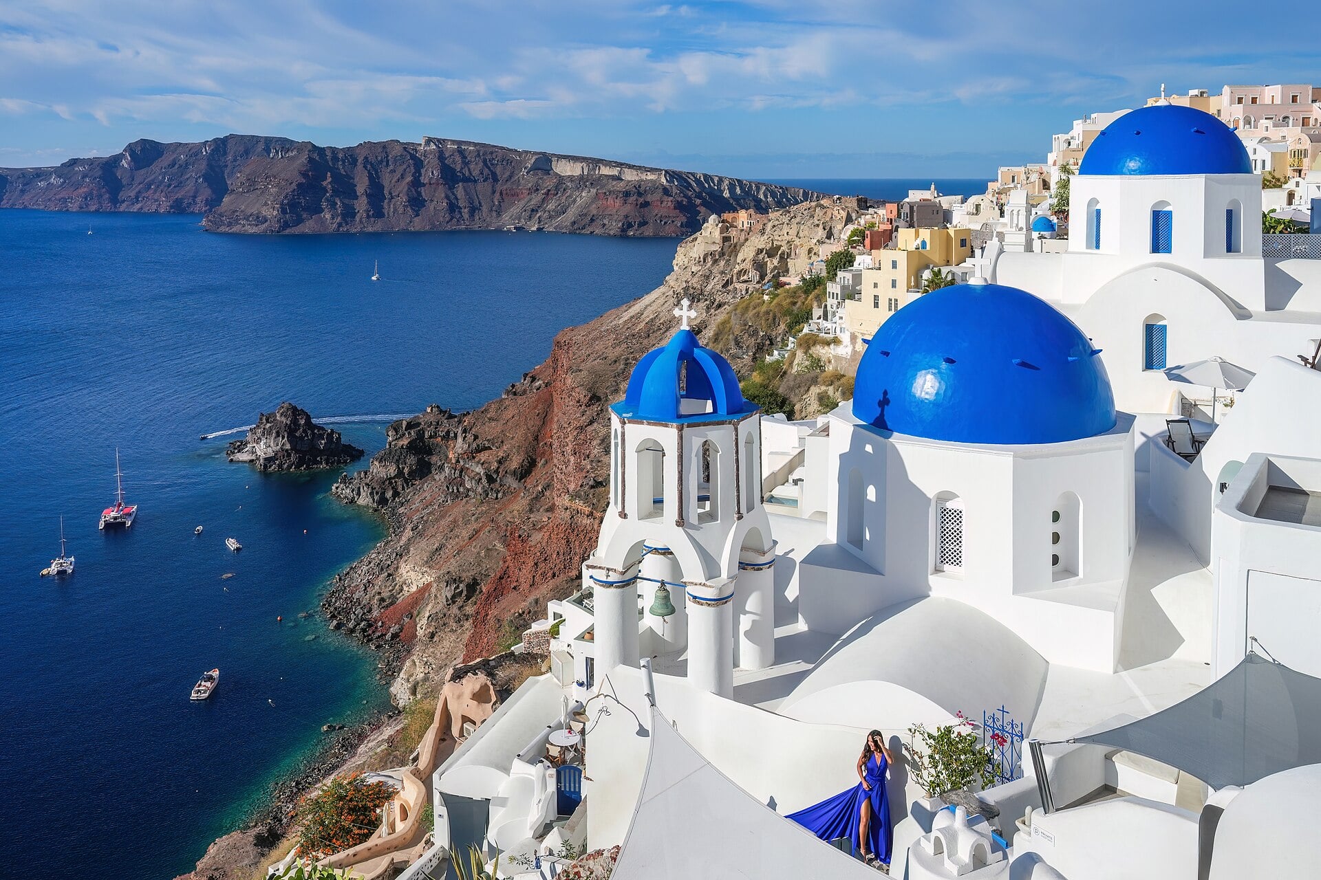 White houses of Oia stacked above Santorini's caldera, Greece.