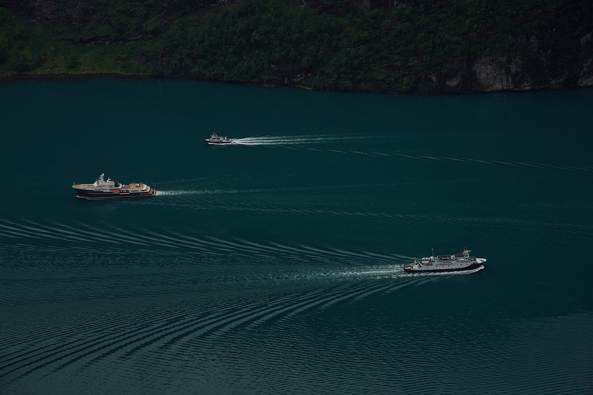 A deep green fjord between mountain walls at Geiranger, Norway.