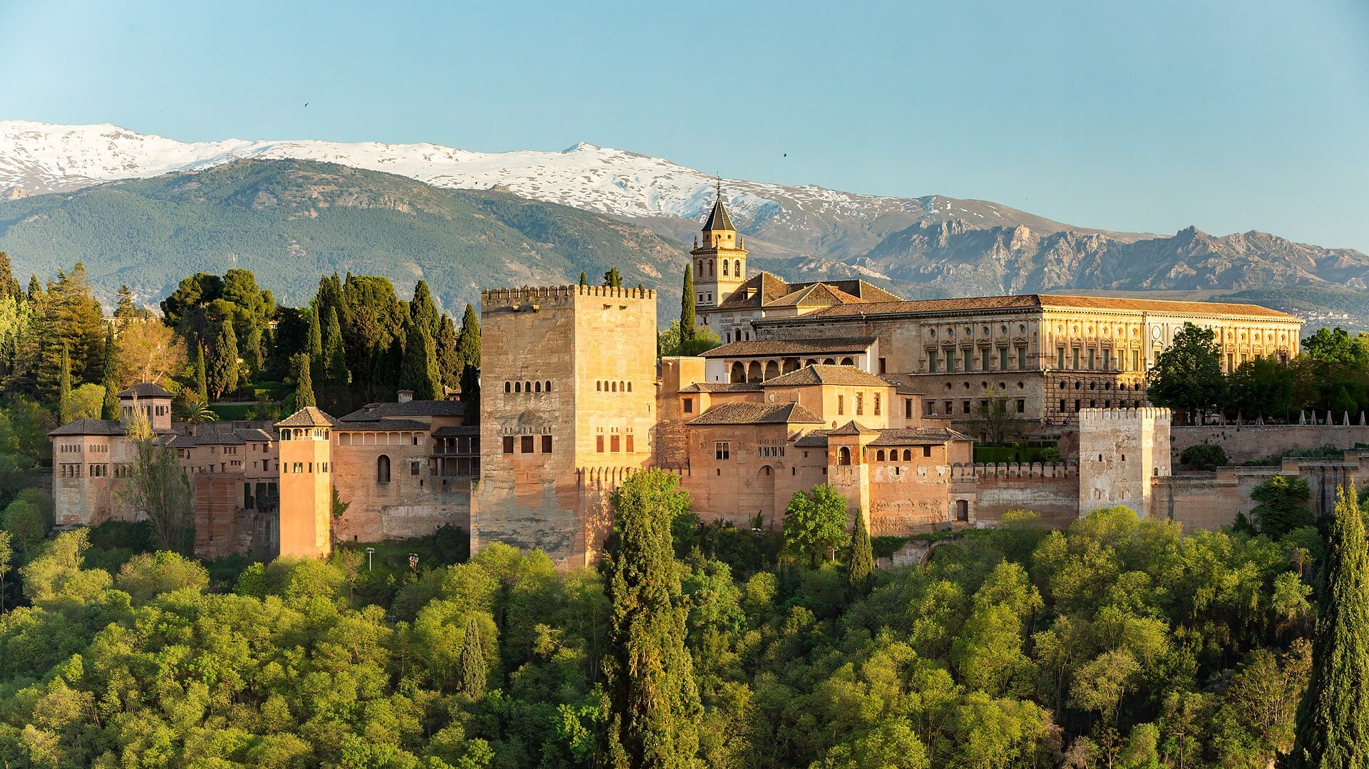 The Alhambra palace complex against the Sierra Nevada, Granada, Spain.