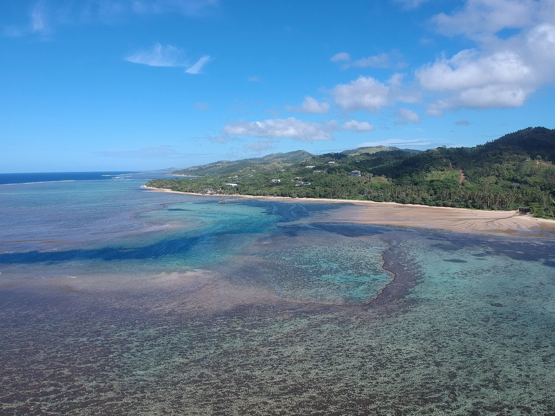 A palm-fringed island and turquoise lagoon in the Fiji Islands.