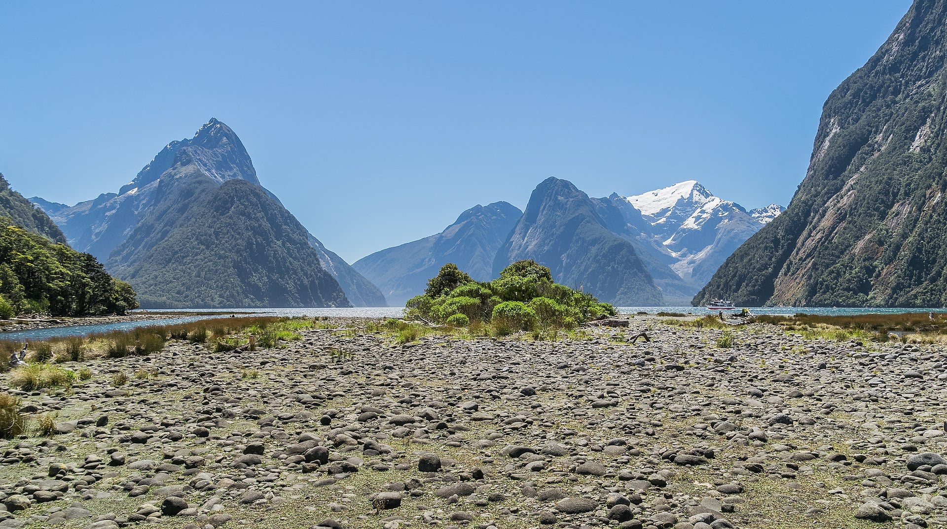 Mitre Peak reflected in the still water of Milford Sound, New Zealand.